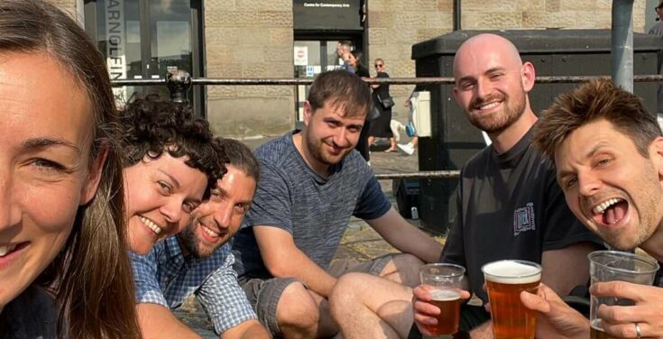 Six enlightened designers and developers sharing post-conference drinks on the Bristol harbour